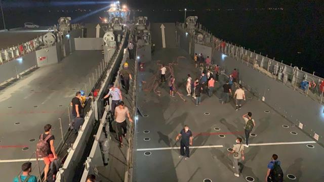 Milas'ta iskelede toplanan vatandaşlar çıkarma gemileriyle tahliye ediliyor